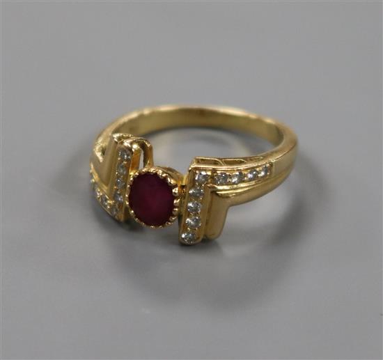 A modern 18ct gold and ruby set ring, with diamond set setting and shoulders, size M.